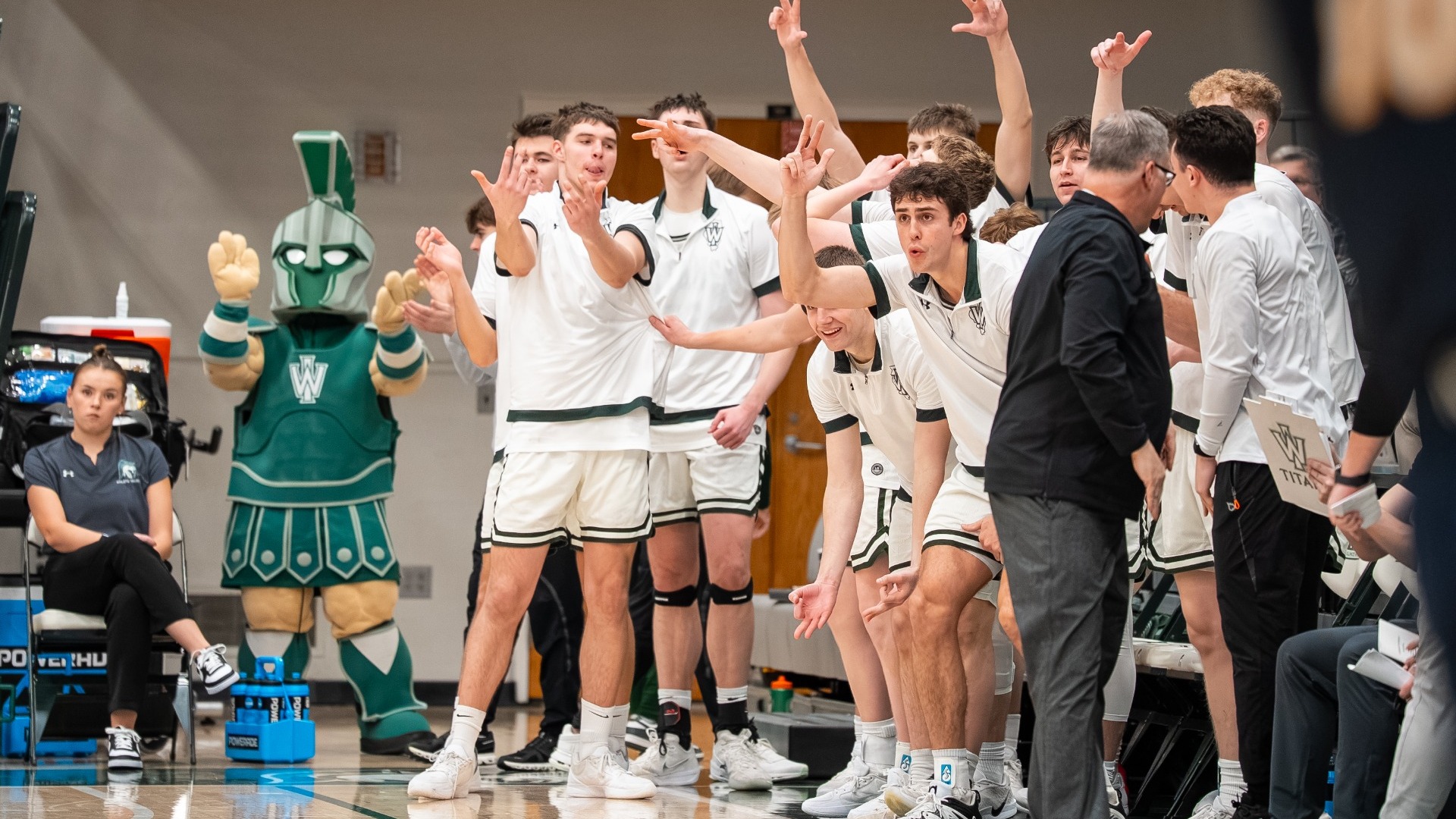 Men's hoops celebrating on the bench