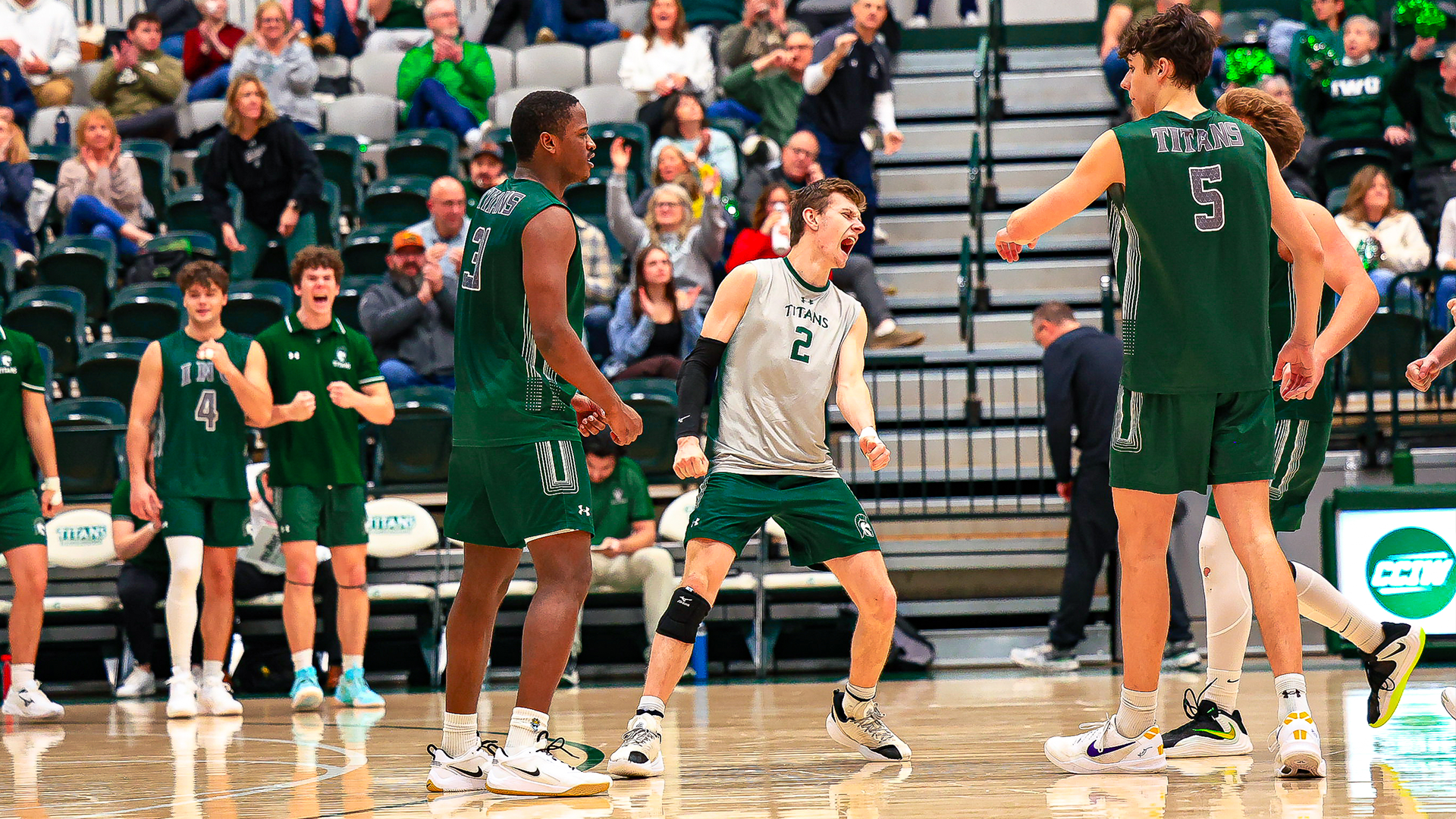 Ben Zima celebrating a point with team against Wisconsin Lutheran College Saturday, Feb. 14