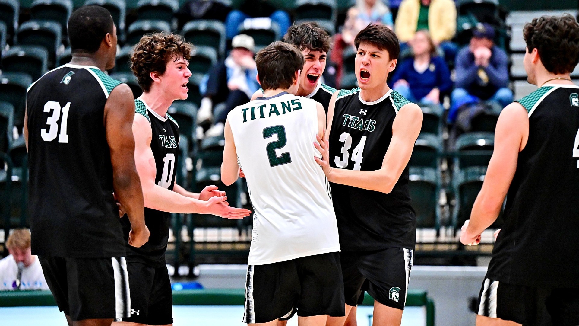 Titans celebrating a point against Augustana March 11, 2026