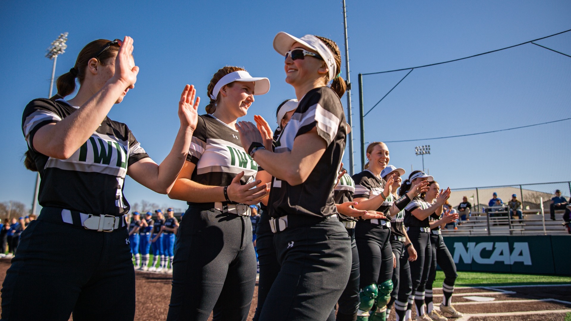 Annika Brown high-fiving down the starting lineup