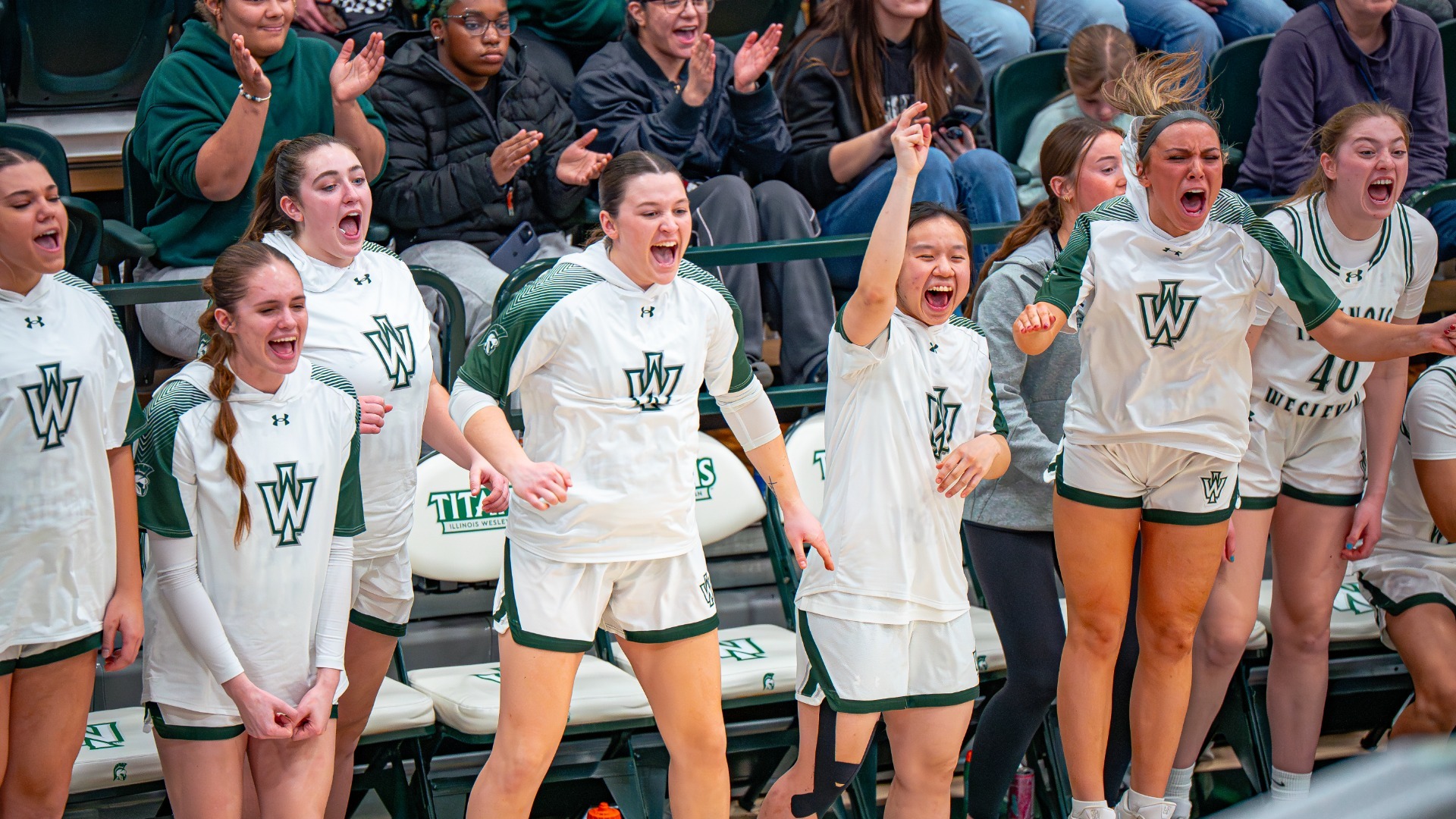 Bench celebrating a big bucket as IWU women's basketball secures the CCIW Regular Season