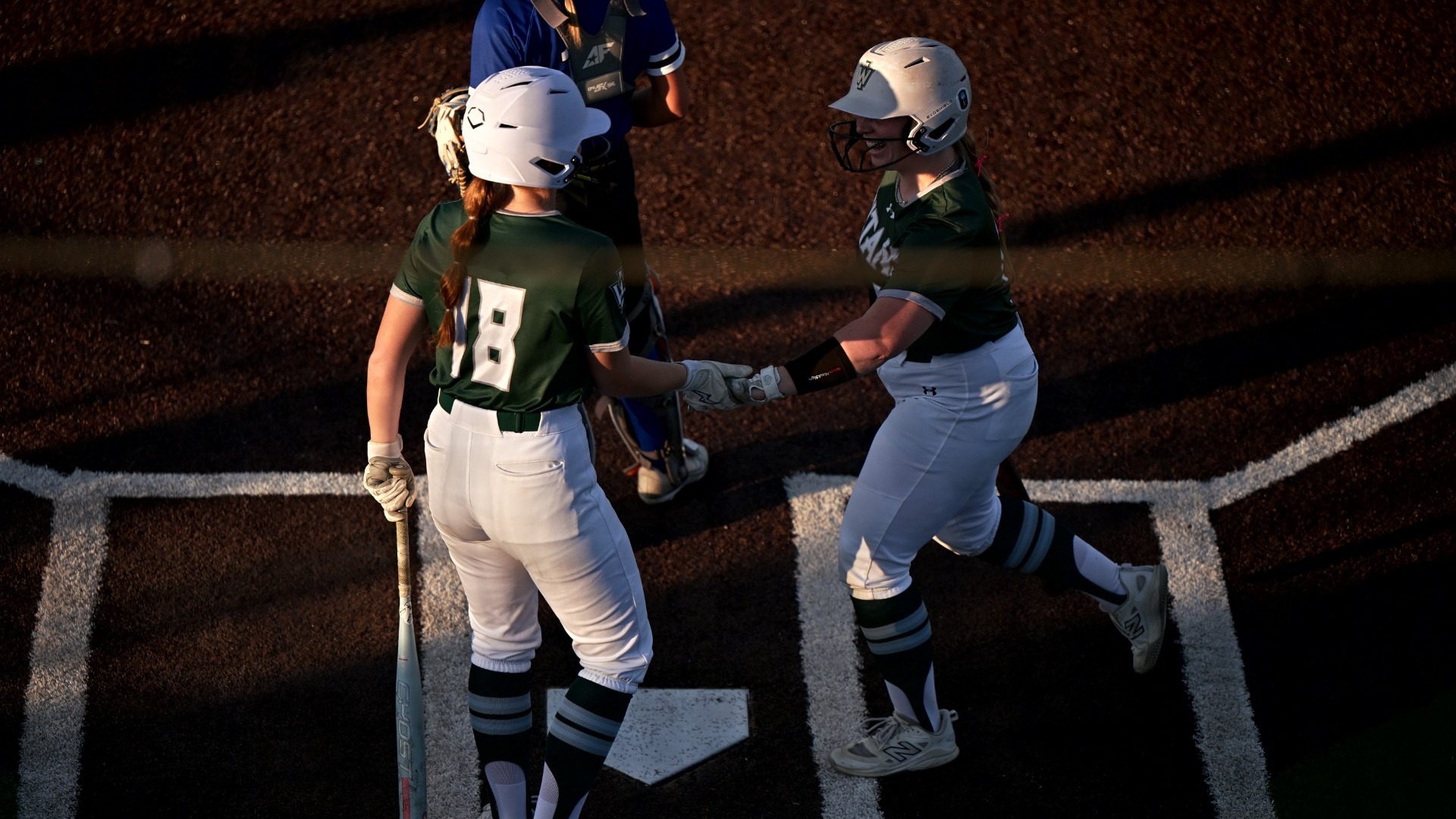 Isabella Boskey and Claire Post celebrating at home plate 