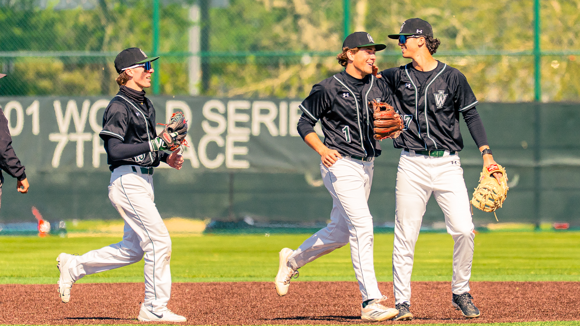 Kieser, Weller, and Hudik smile as they run off the field