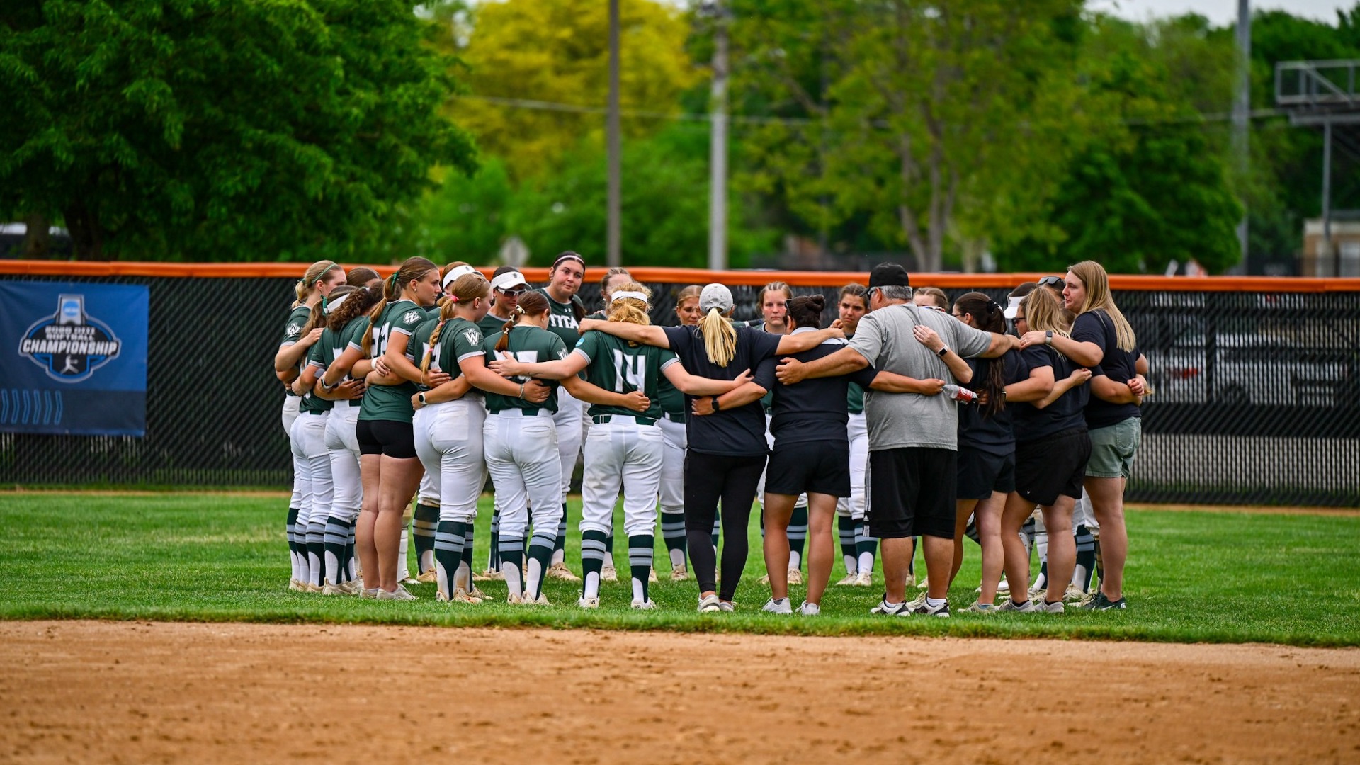 Softball group huddle post game against Redlands