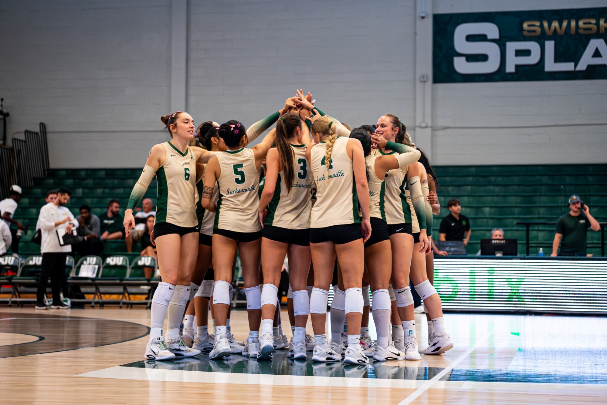The Jacksonville volleyball team huddles during its match against FGCU.