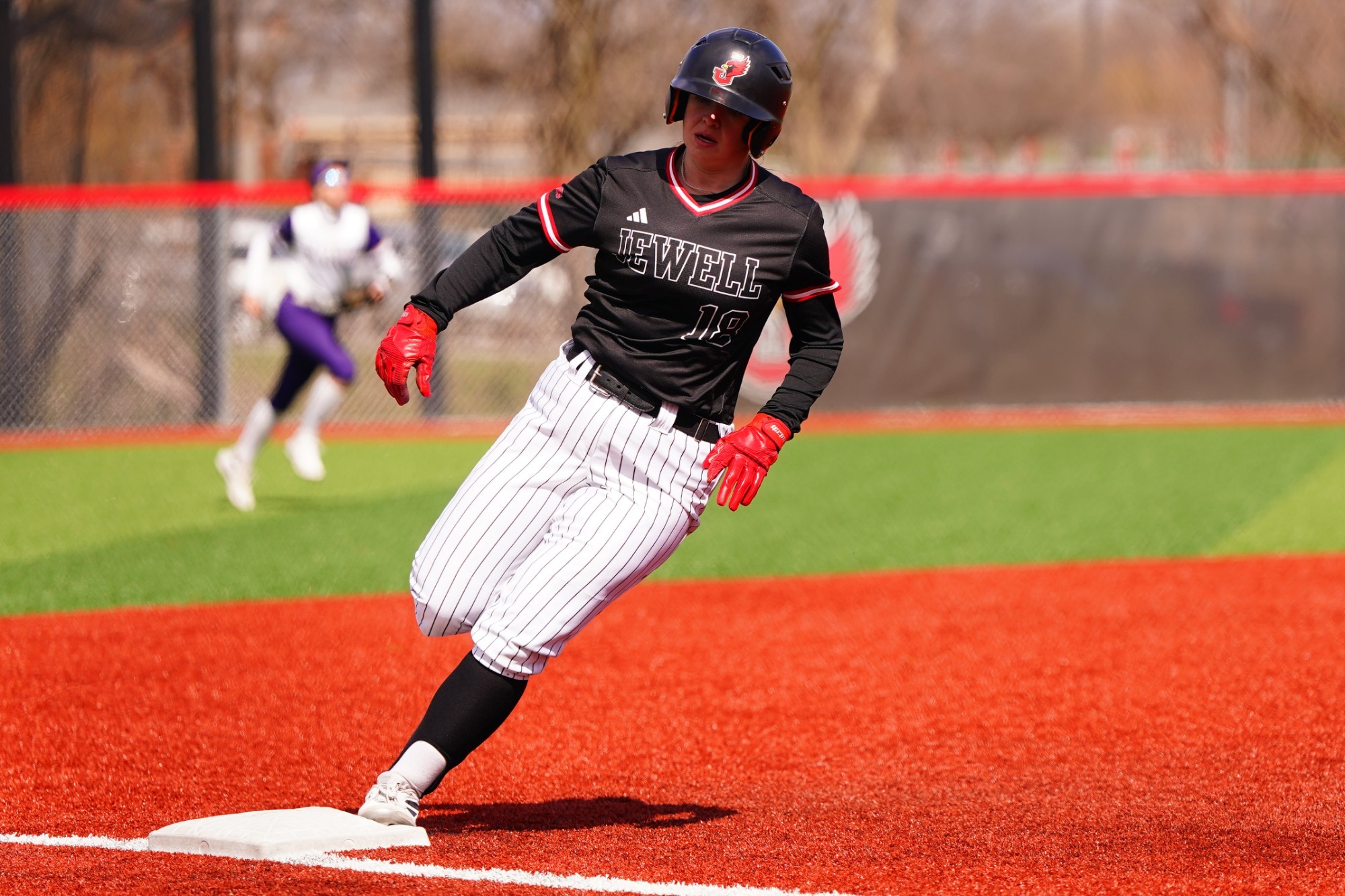 Tori Woodard rounding third base 