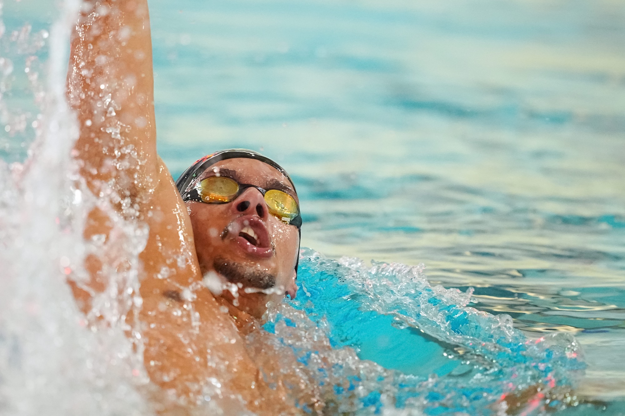 Afonso Silva swims in the pool, close up shot backstroke with water in the background