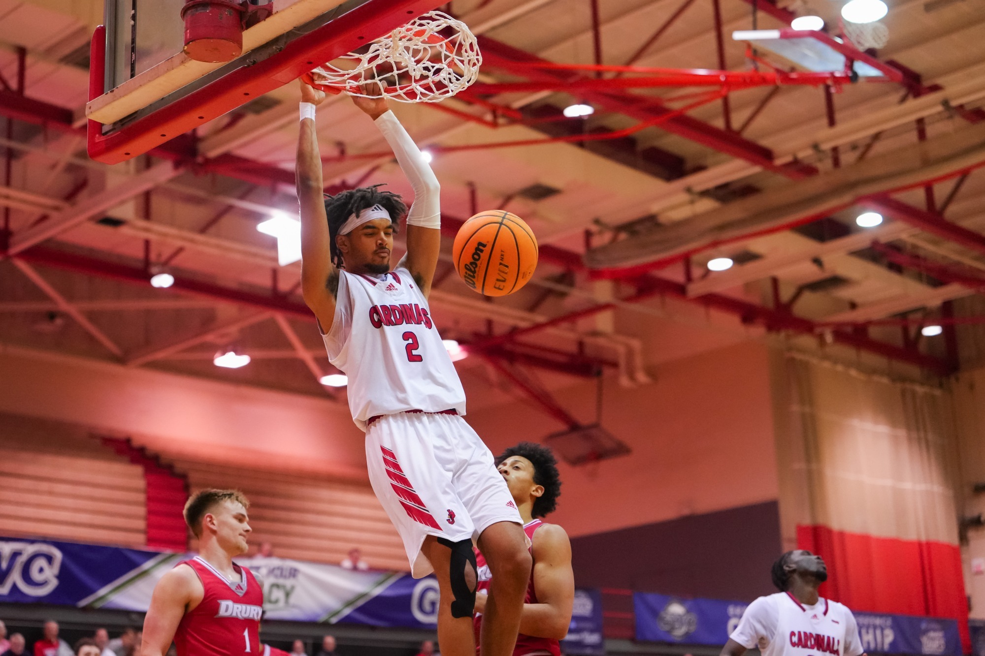 Justice Sutton hanging on rim after dunk