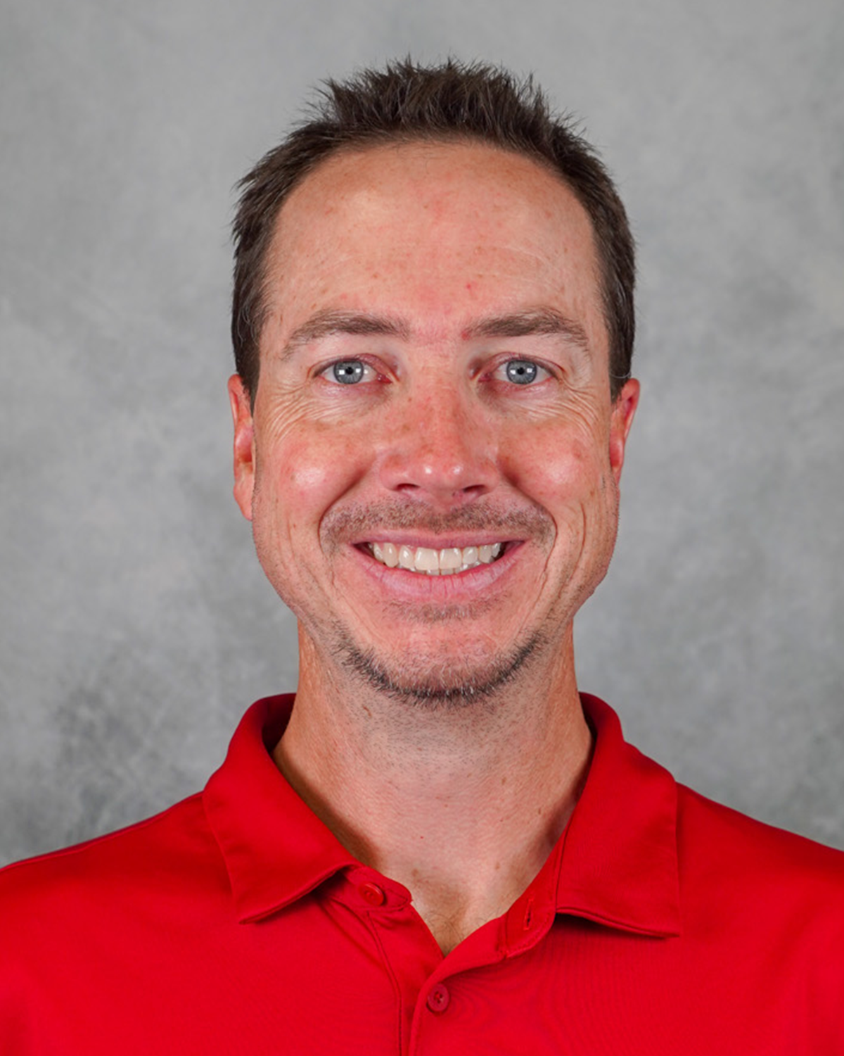 Head Coach Keith Buderus coach in a red Jewell polo shirt