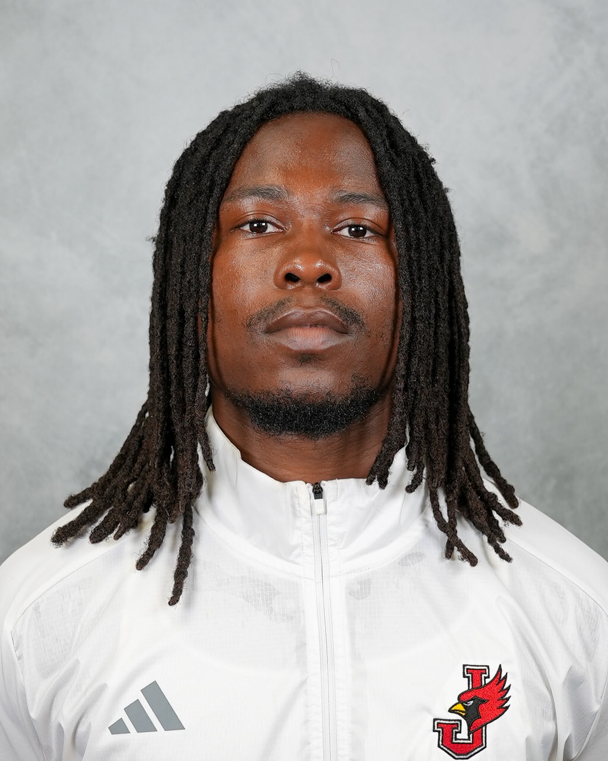 Headshot of William Jewell football coach Teriyon Cooper wearing a white Jewell Football pullover in front of a gray background