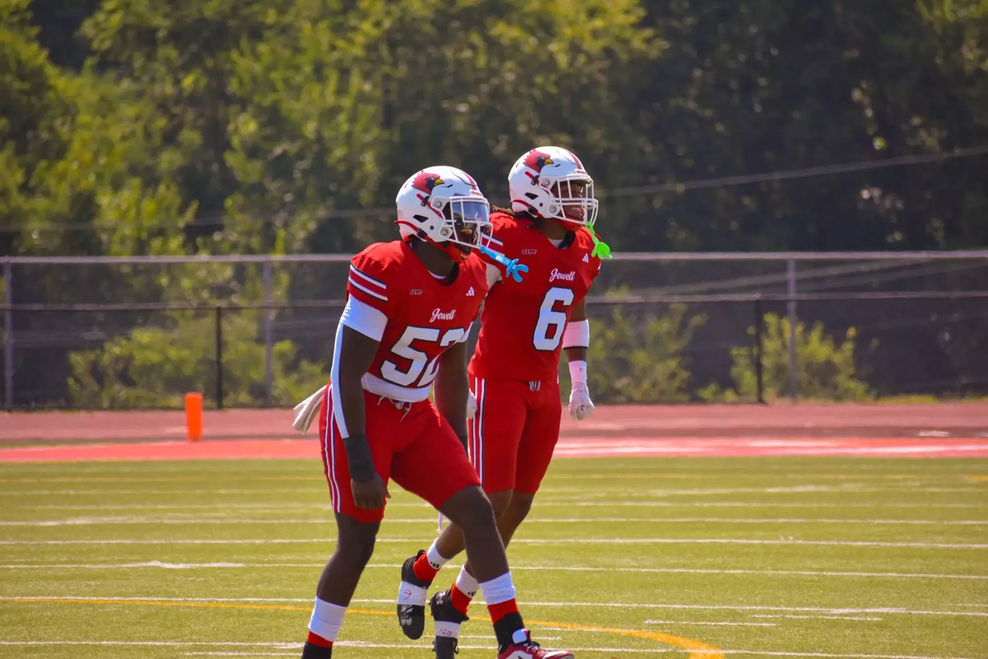 Du'Vaughn Williams celebrates a big play with Yasir Winston in the background, both are wearing red football uniforms and white helmets