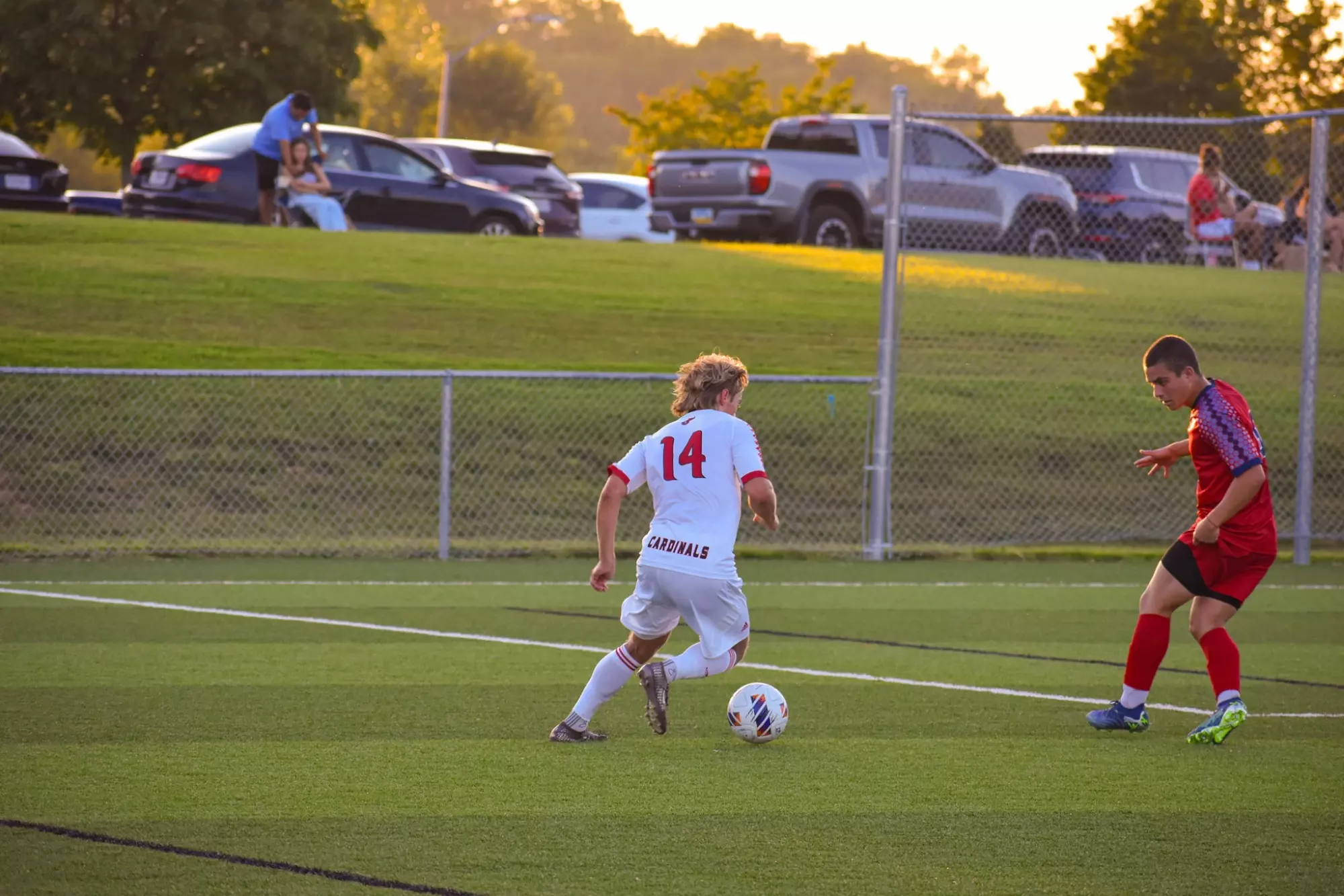 Hugo Nordenberg dribbled the soccer ball in a white uniform with number 14 on the back