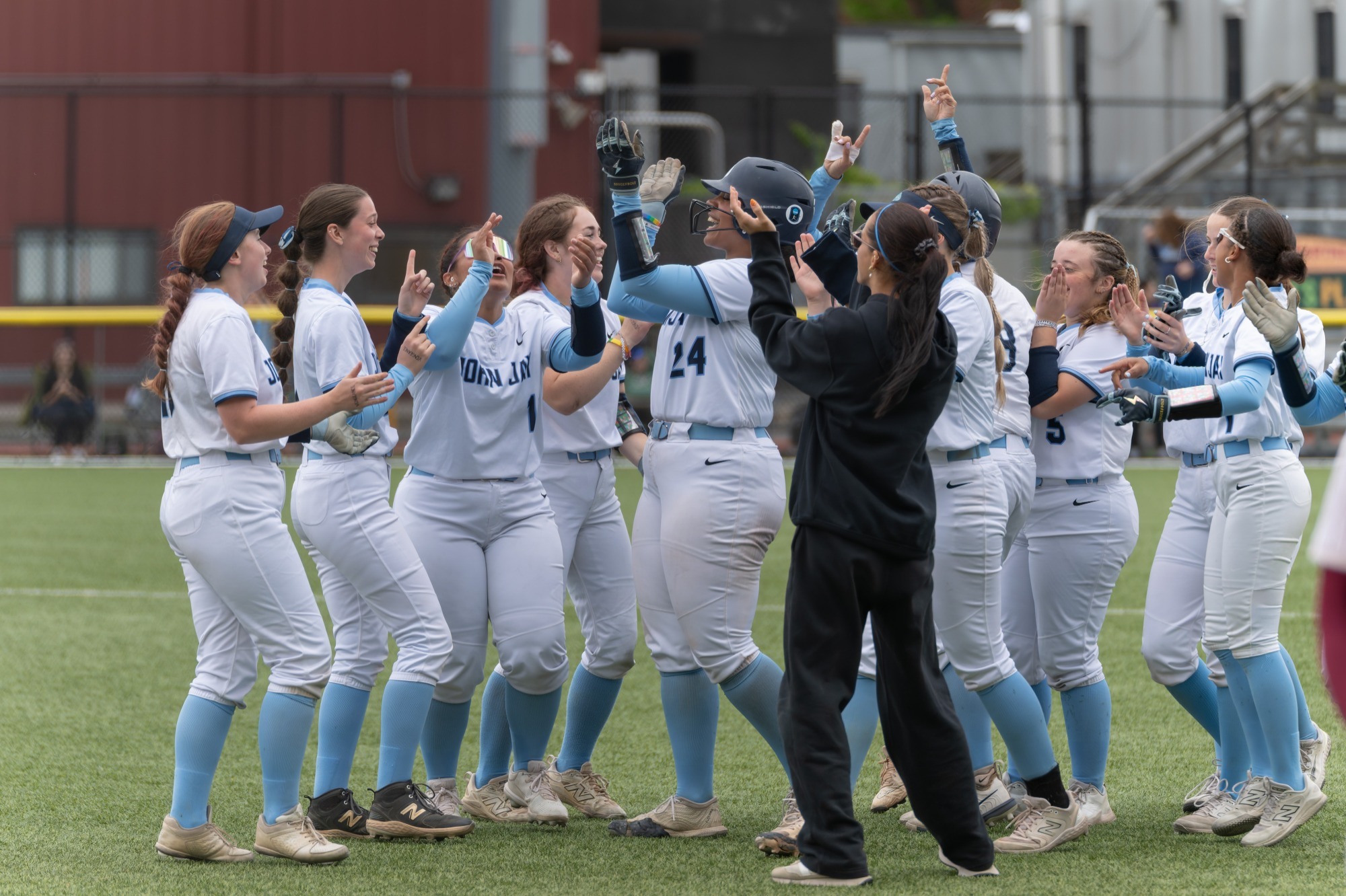 John Jay softball begins to celebrate following their fourth CUNYAC title 