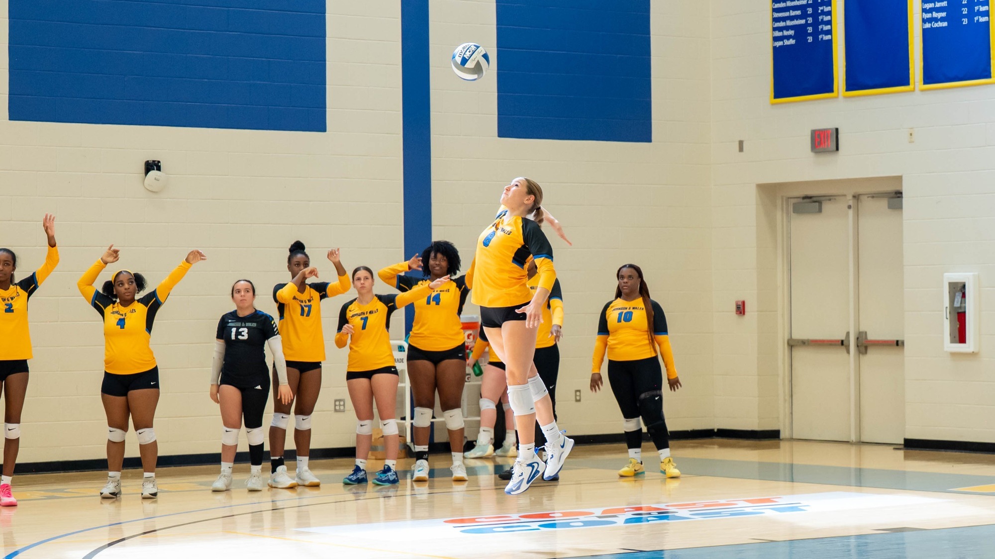 woman serving a volleyball