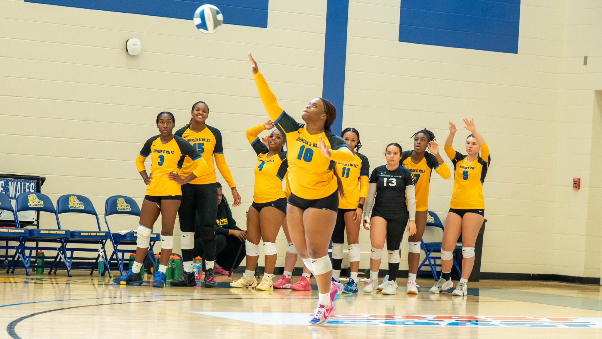 woman serving a volleyball