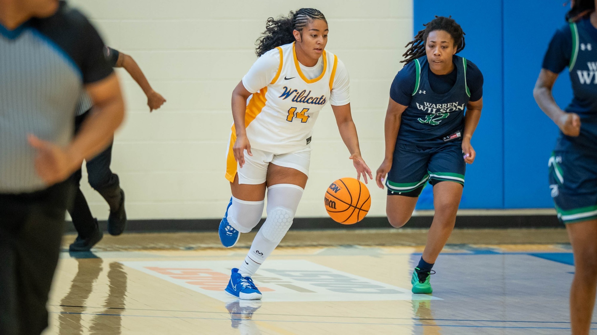 woman dribbling a basketball
