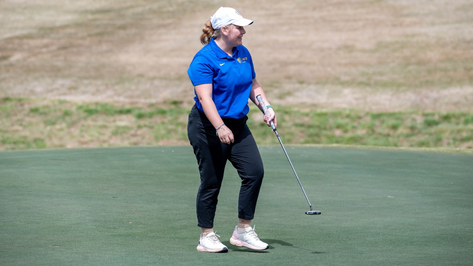 woman putting a golf ball