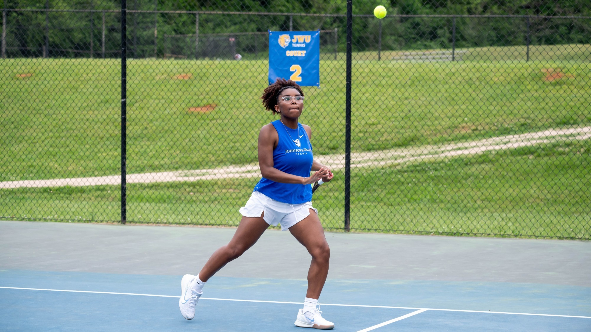 woman hitting a tennis ball