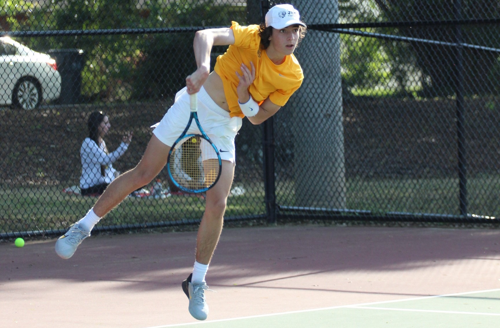 man hitting a tennis ball