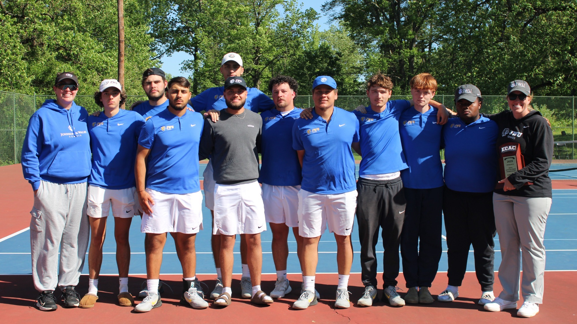 group of people standing on a tennis court
