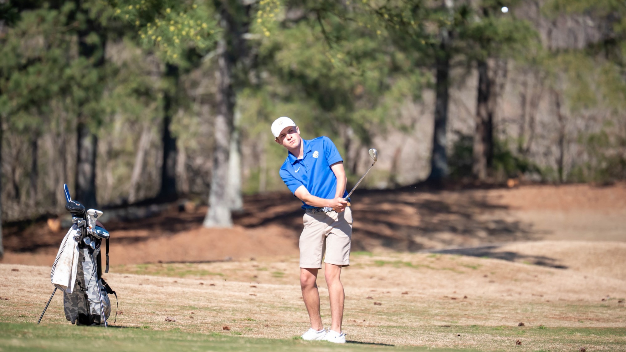 man hitting a golf ball