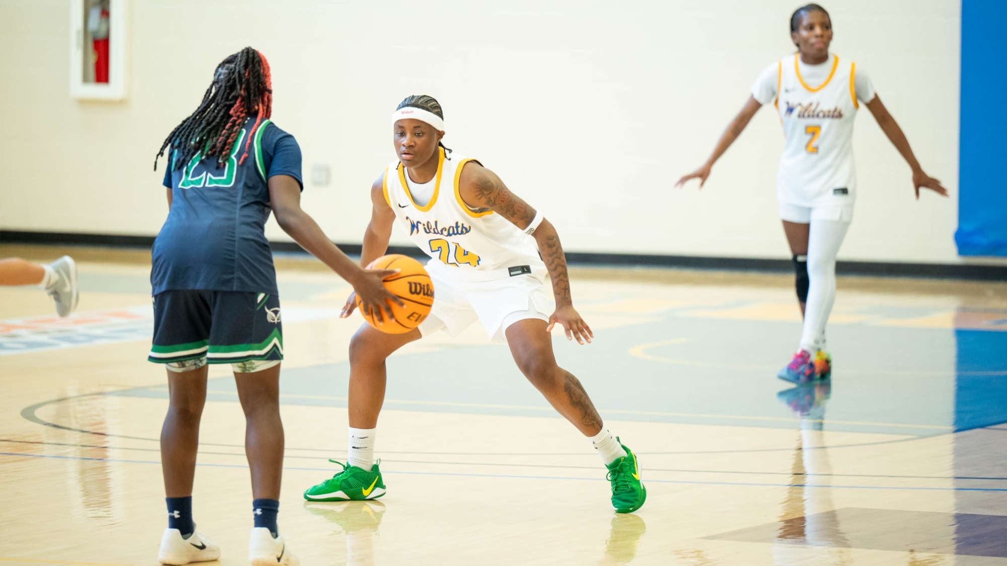 woman guarding a basketball player