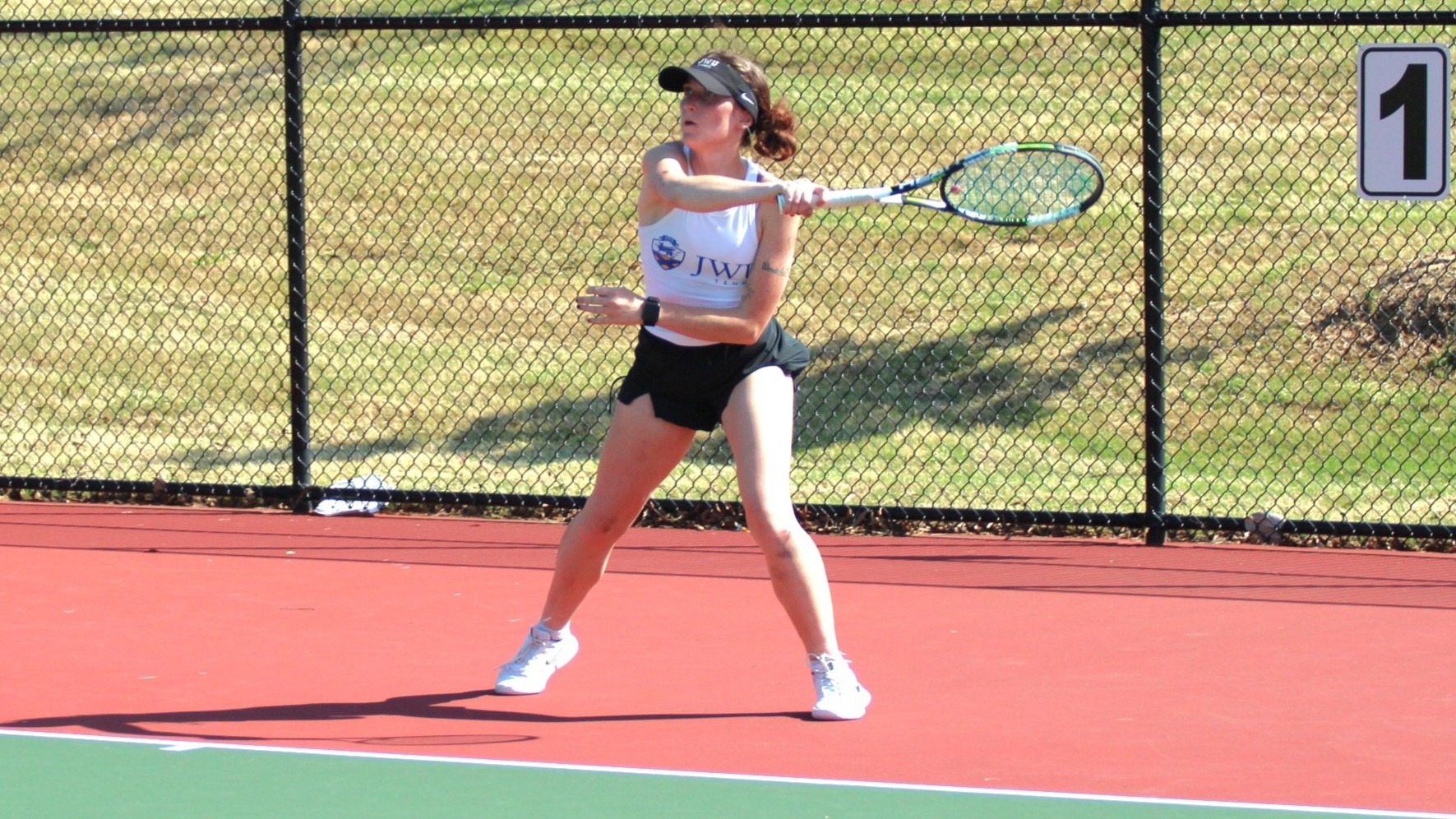 woman hitting a tennis ball