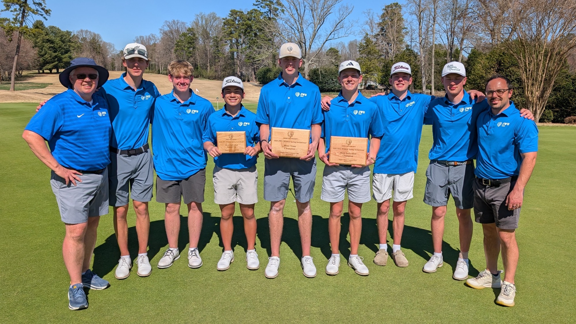 men holding plaques on a golf course
