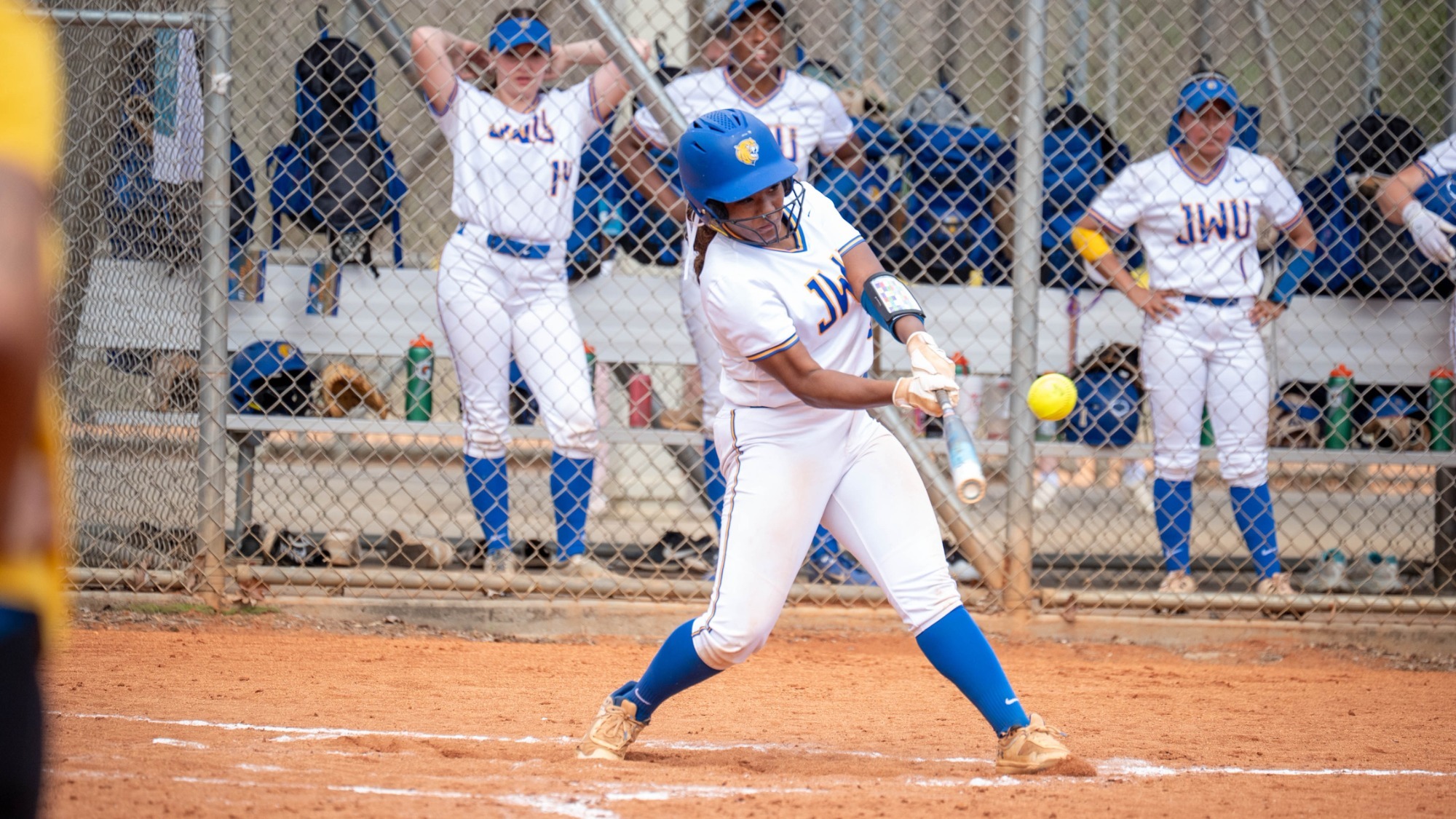 woman swinging a softball bat