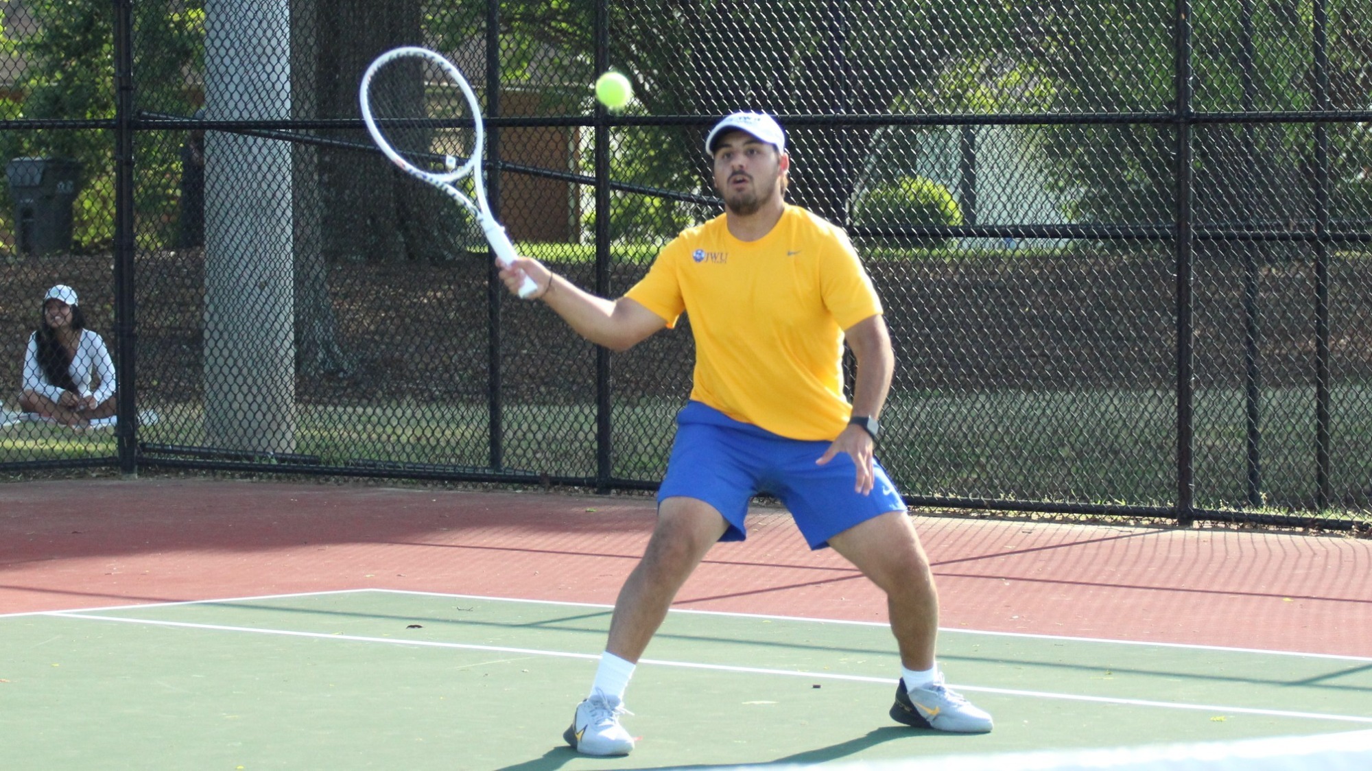 man hitting a tennis ball