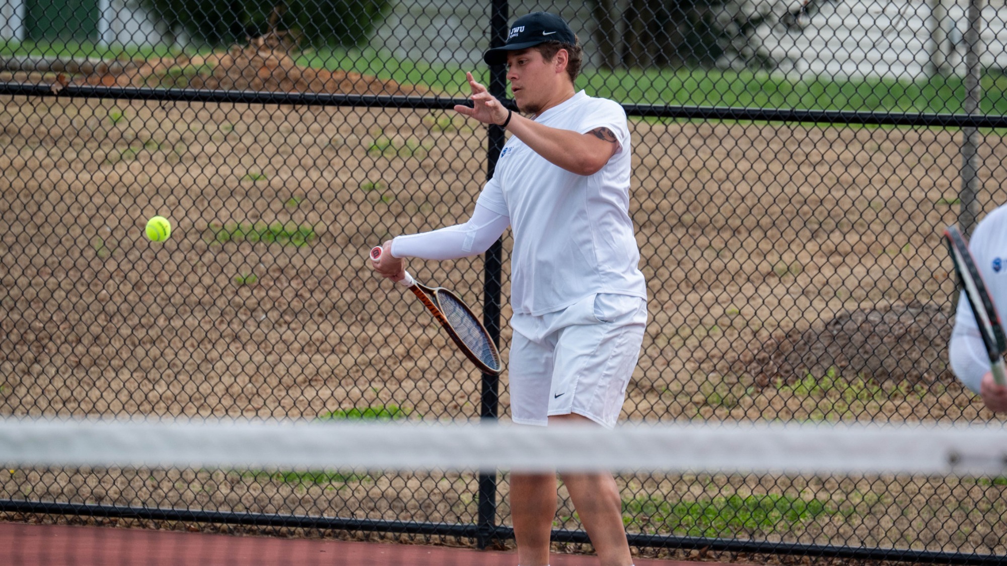 man hitting a tennis ball