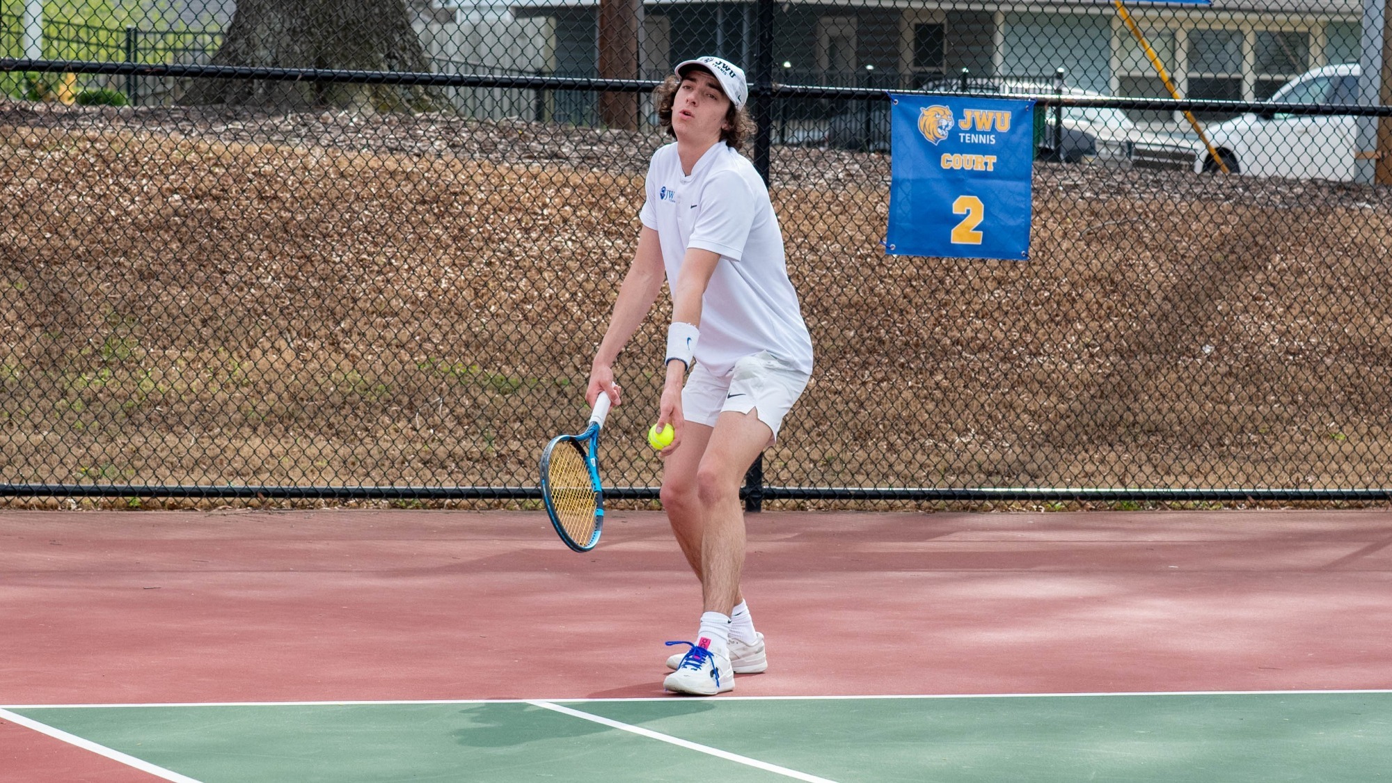 man serving a tennis ball