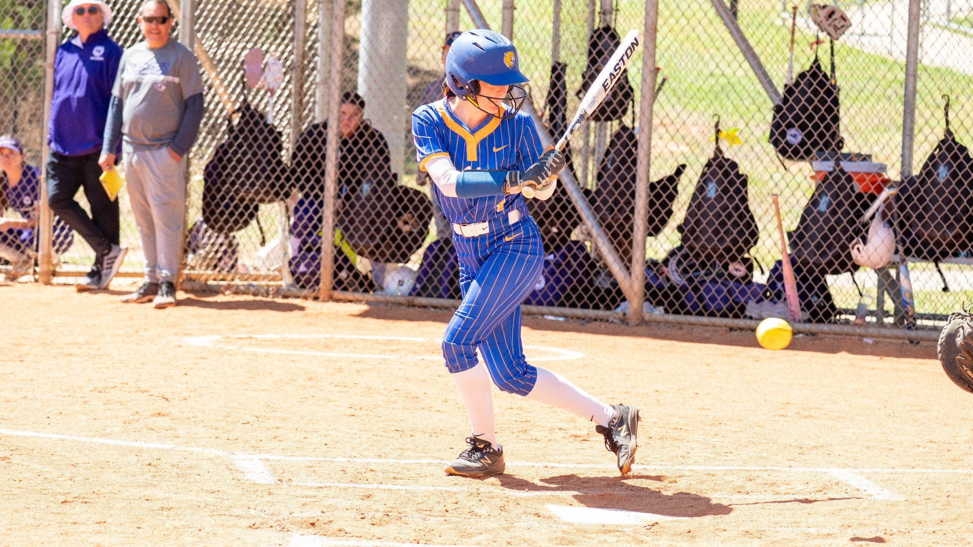 woman swinging a softball bat