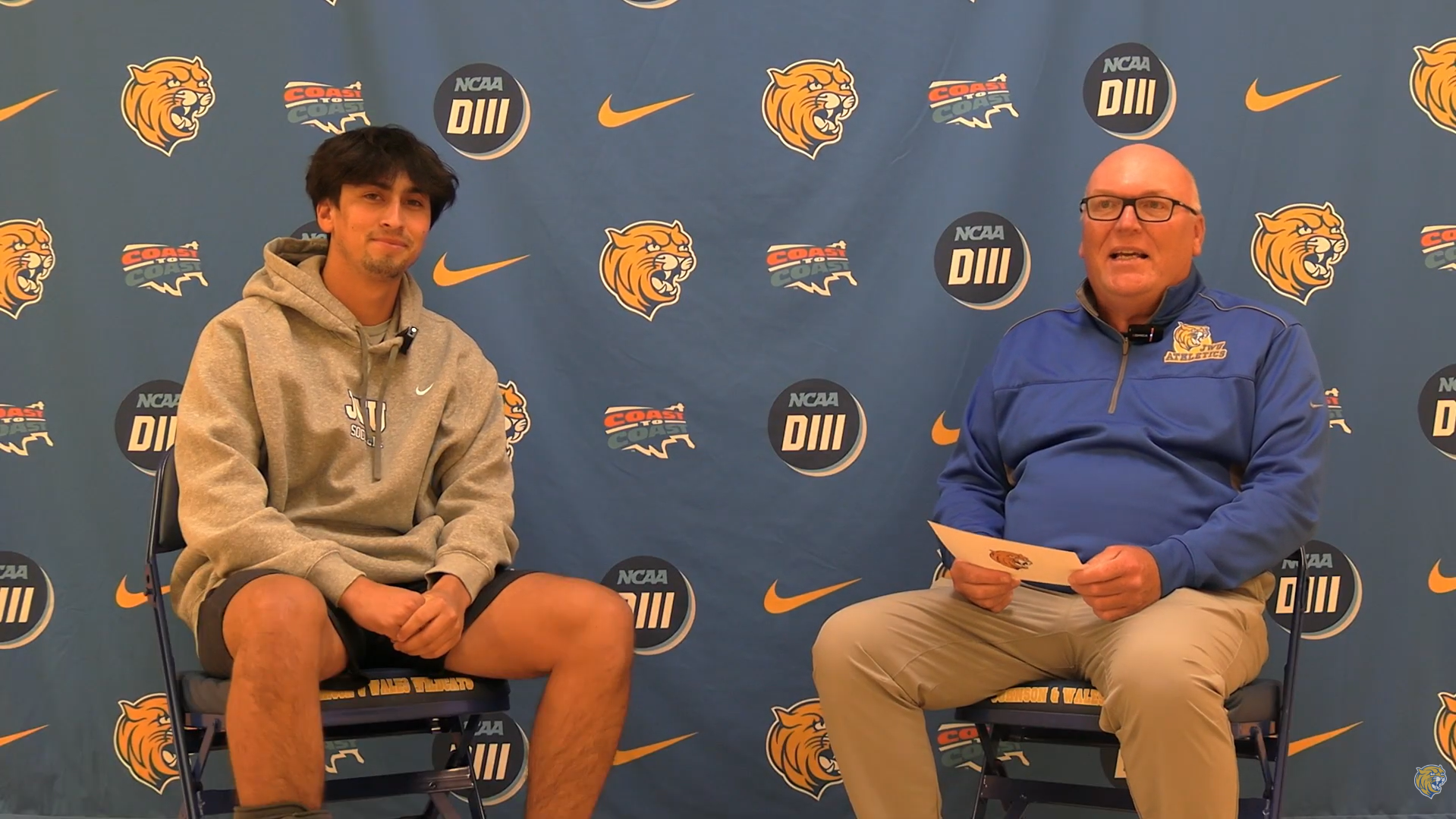 two men sitting down talking