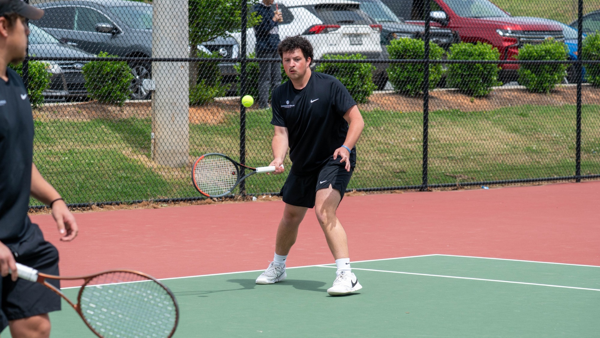 man hitting a tennis ball