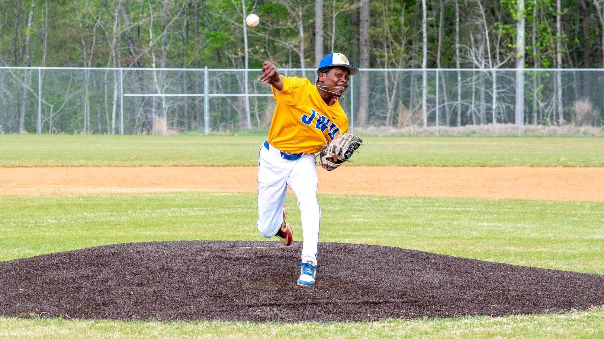 man pitching a baseball