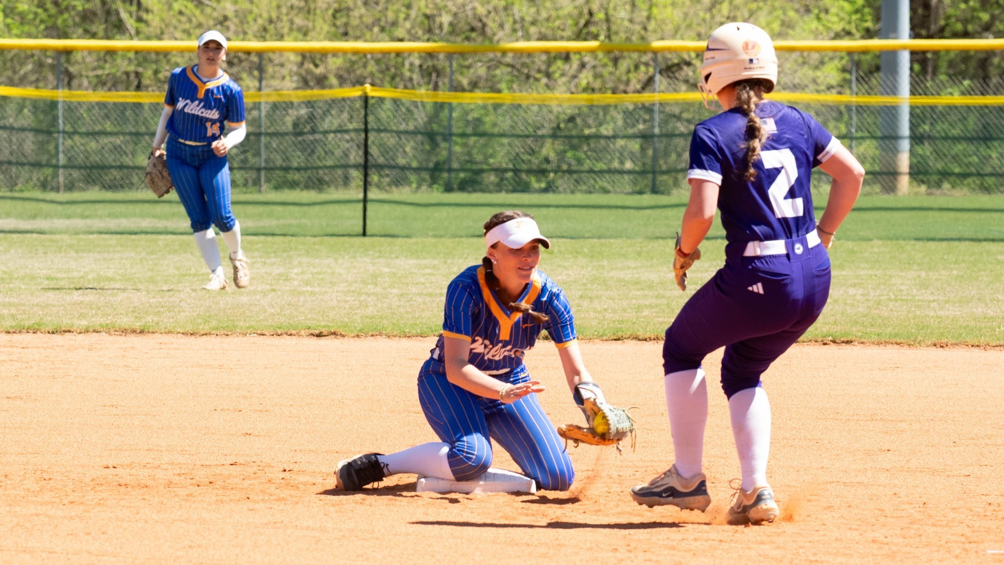 woman tagging out a runner in softball