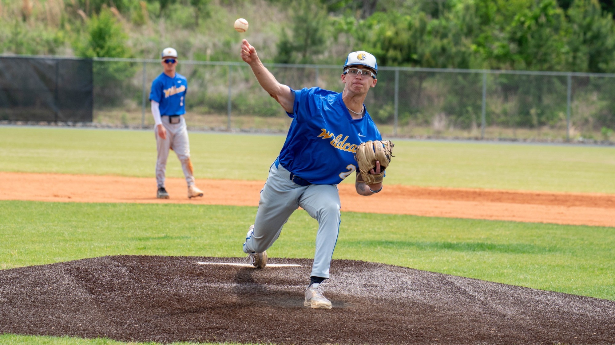 man pitching a baseball