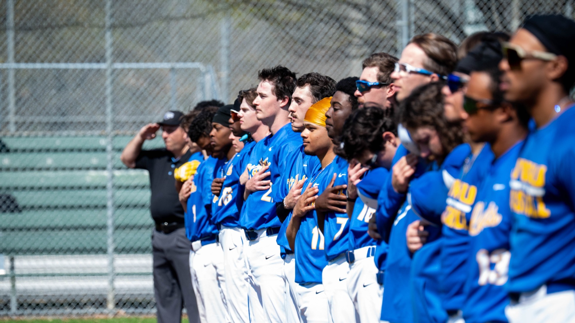 baseball players standing for the national anthem