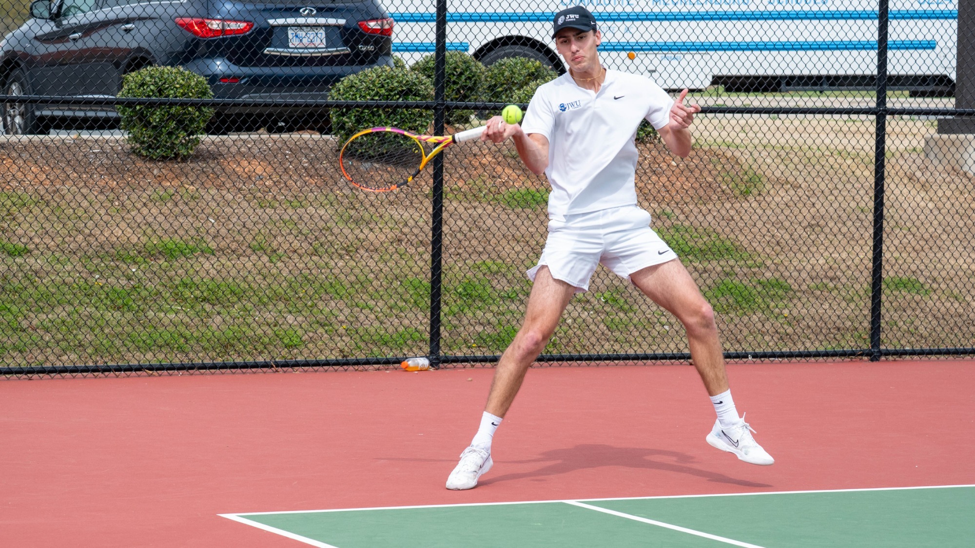 man hitting a tennis ball