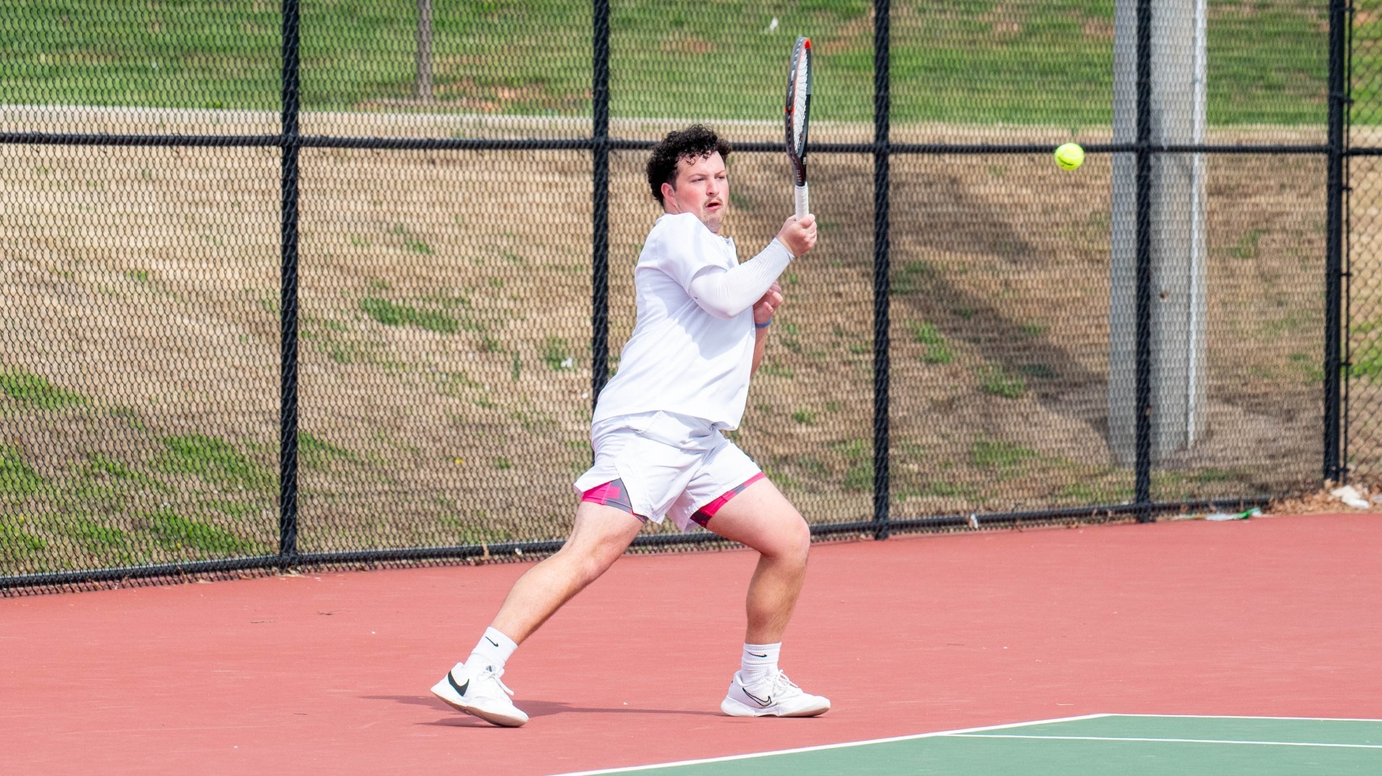 man hitting a tennis ball