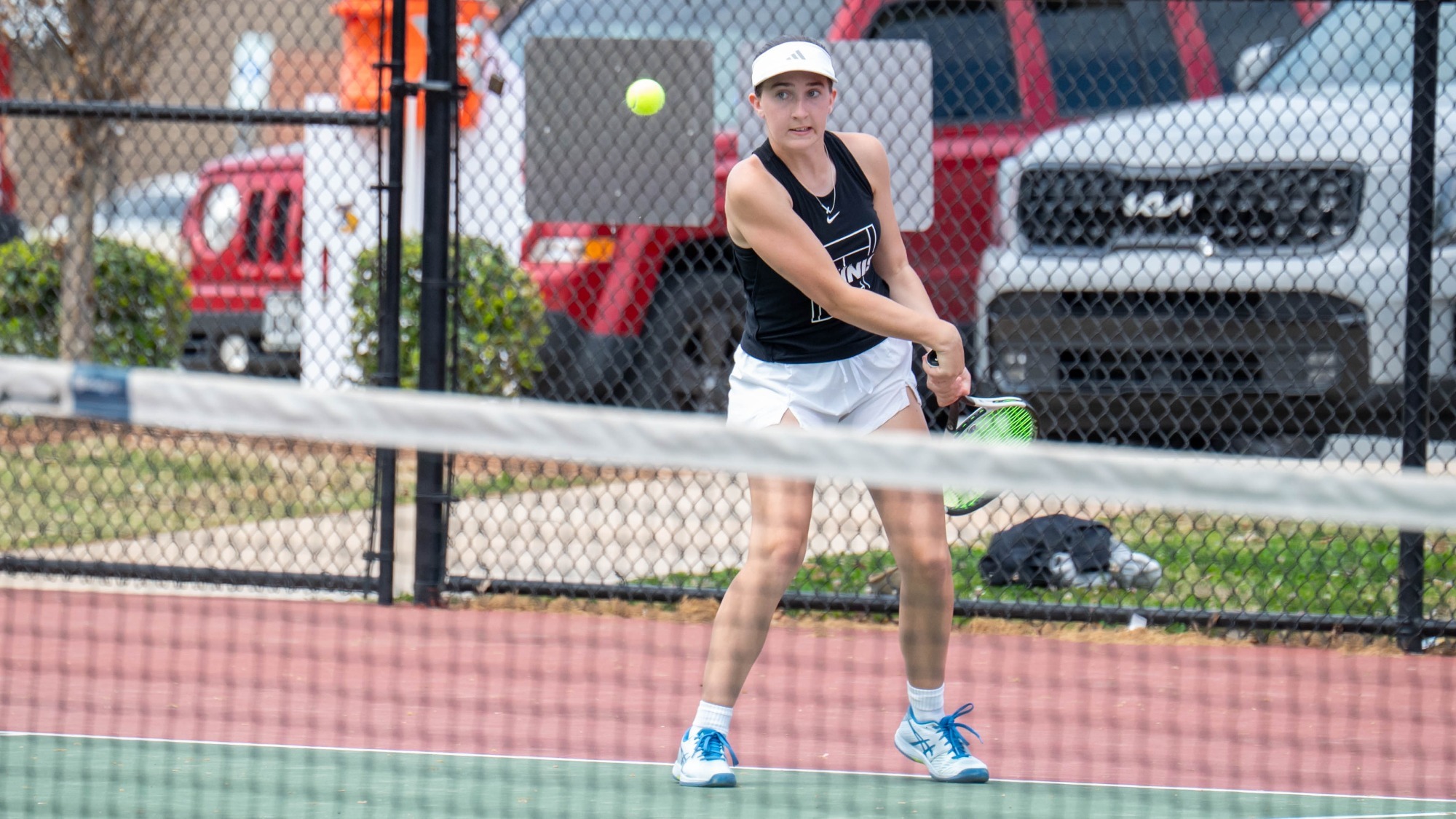 woman hitting a tennis ball