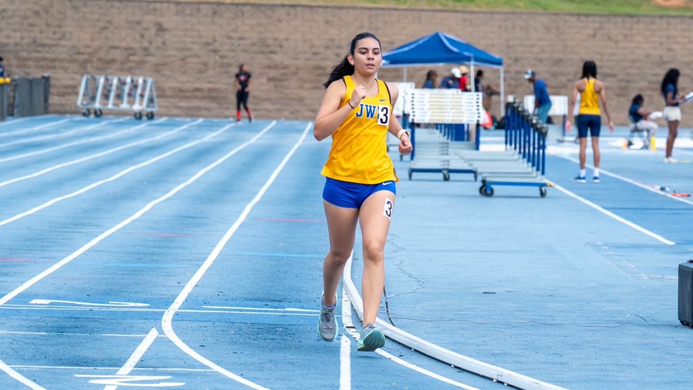 Woman running on a track.
