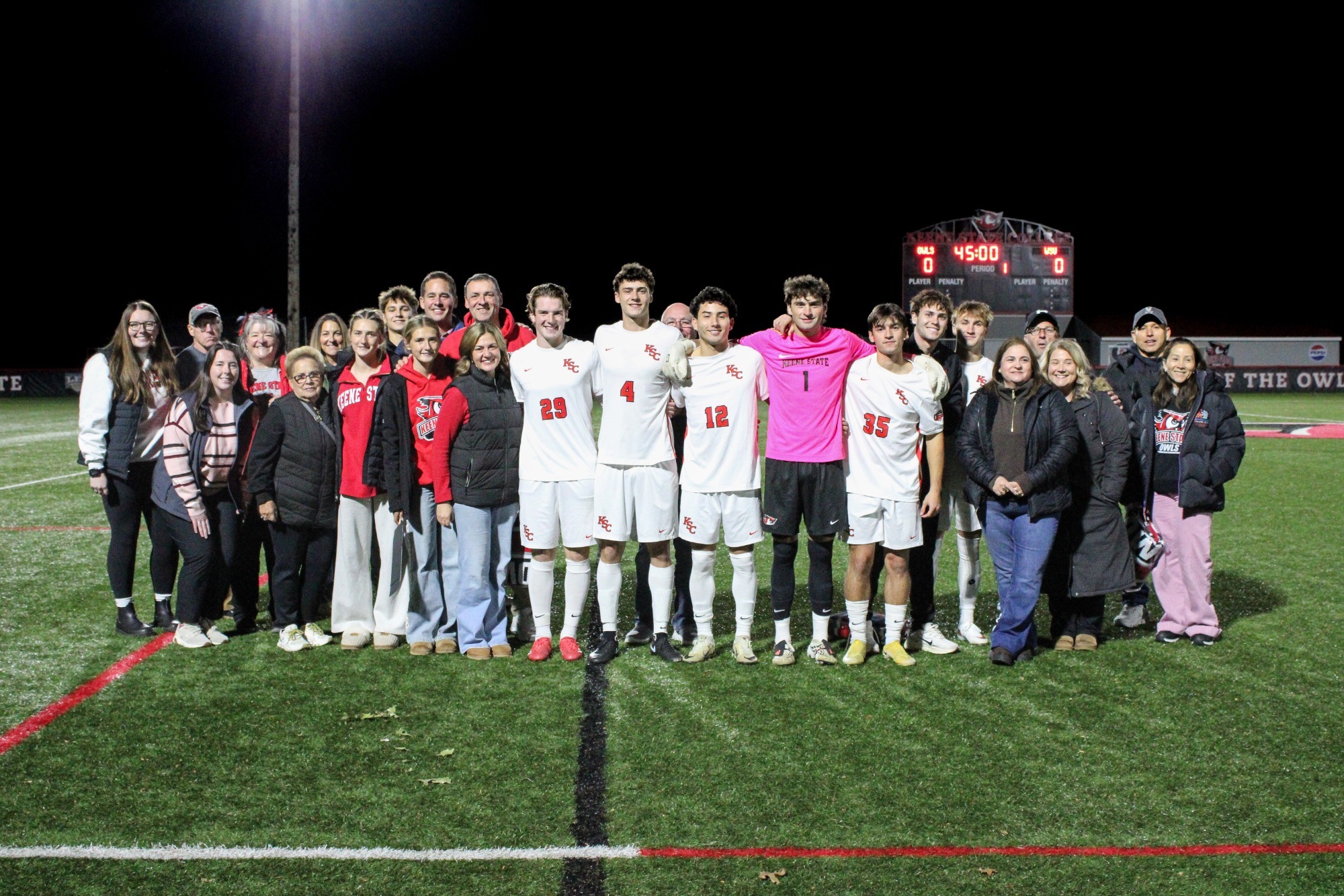 Soccer players stand for group photo together