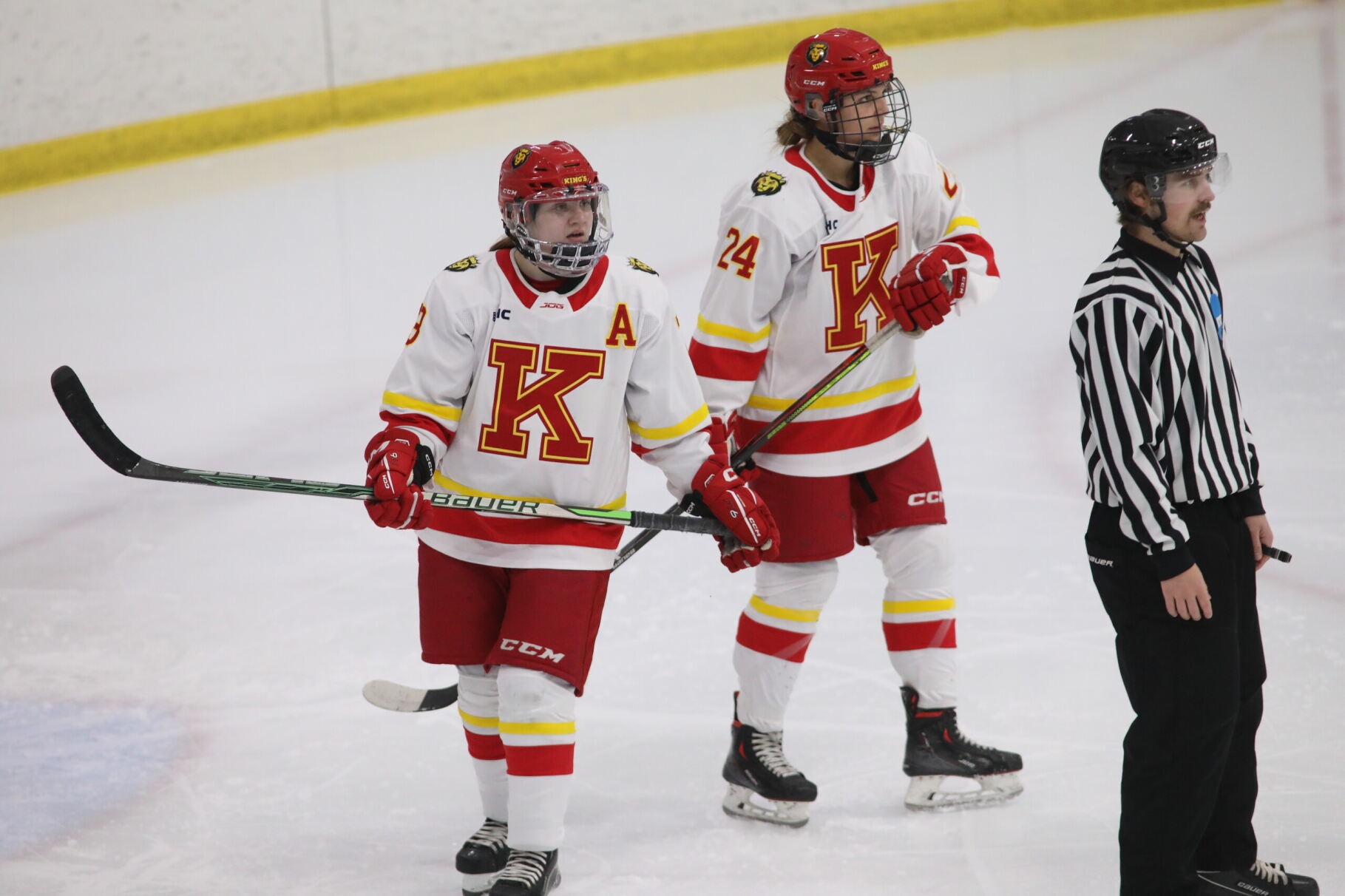 Two King's College Women's Ice Hockey players skate on the ice during a game against Wilkes University