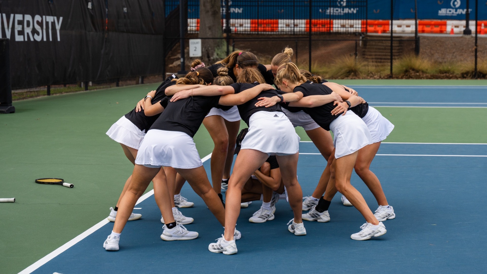 Kennesaw State women's tennis team huddles.