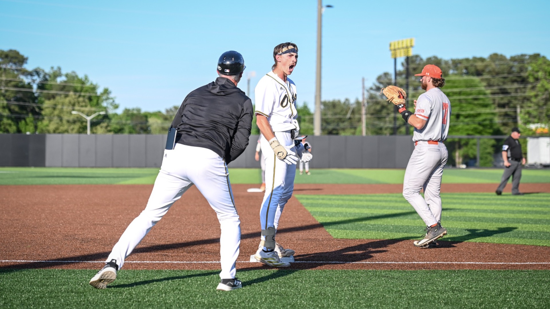 Chris Cole celebrates after hitting an RBI triple