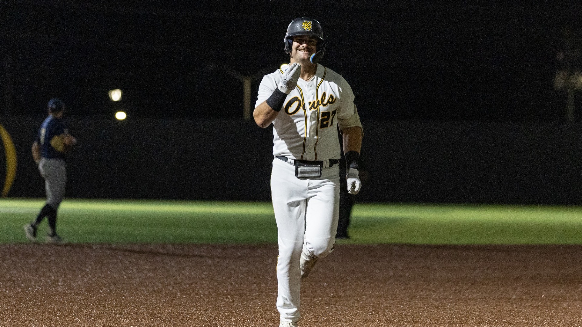 Charlie Jones smiles as he jogs to third base after hitting a home run