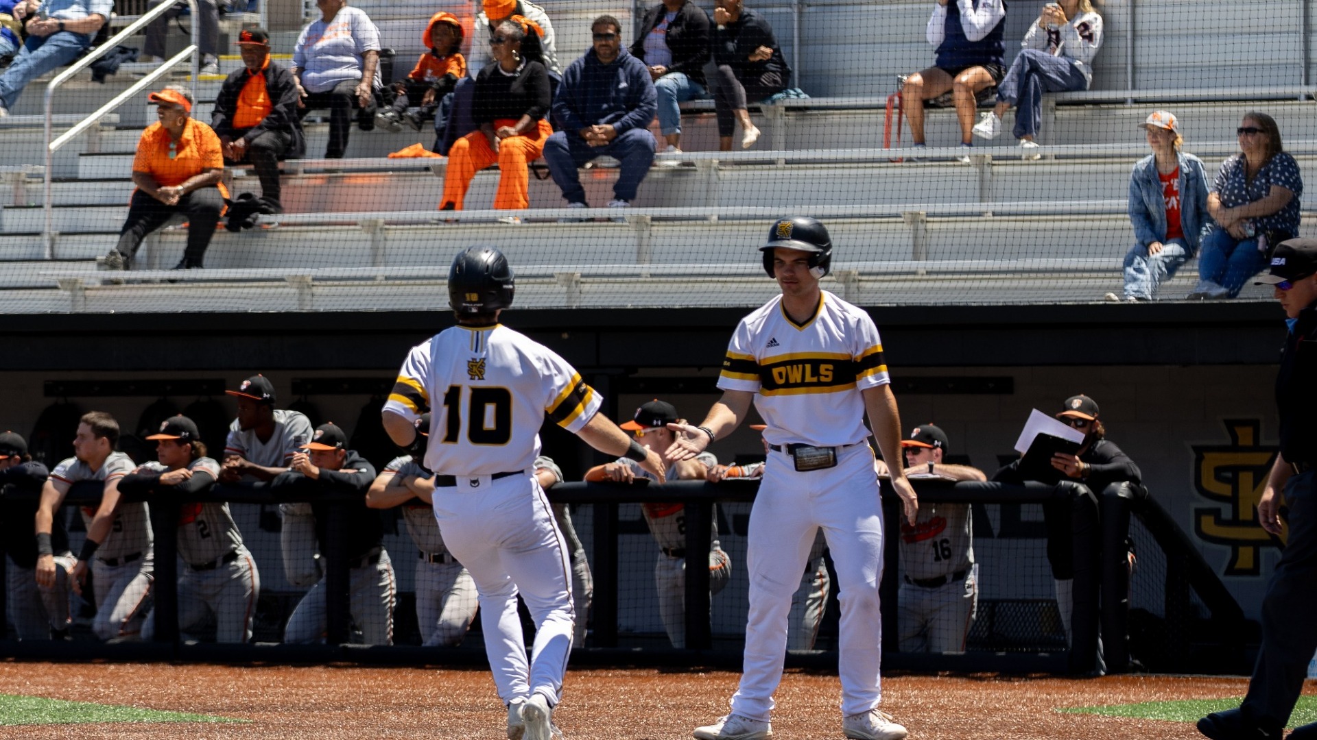 Wesley Alig high-fives James McGee after scoring a run