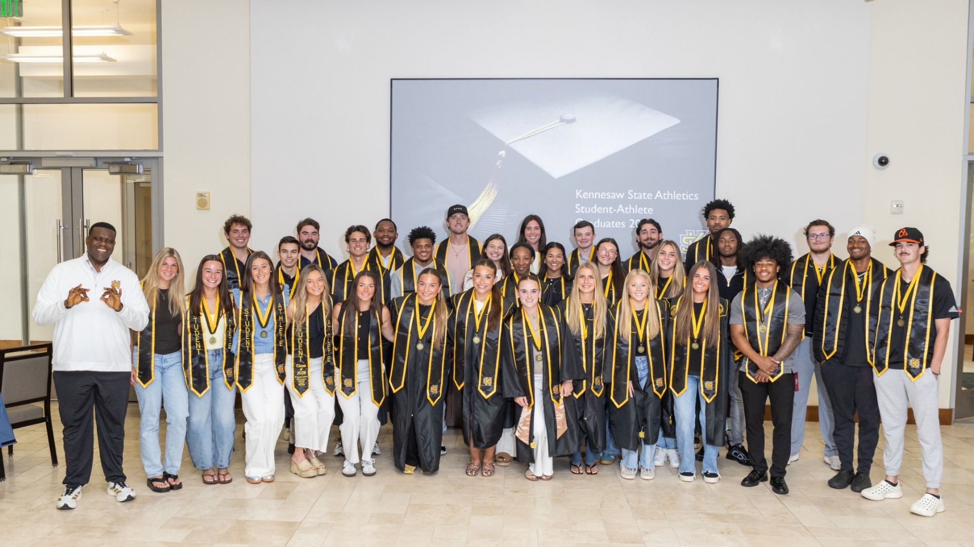 Kennesaw State director of athletics Milton Overton celebrates with the Owls' Spring 2026 graduating class.